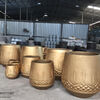 SO IMPRESSIVE: HOANG POTTERY’S COPPER-GOLD PAINTED CEMENT PLANTERS.